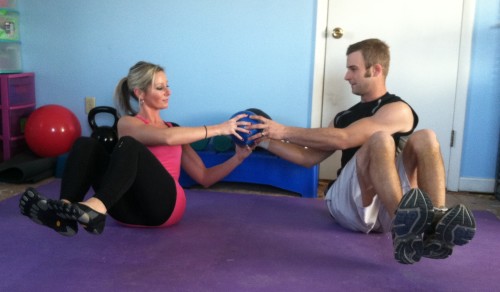 SIDE OBLIQUESSit with your partner beside you a little less than arms length away. Bend your knees and lean back to a 45 degree angle. Lift your feet off the floor if possible. If that is too hard, keep your feet on the floor. Holding a medicine ball, twist to your partner and hand them the medicine ball. You and your partner will both twist to the oppostite side. As you twist to the other side, your partner will hand you the ball. Keep twisting and handing each other the ball for the prescribed number of reps.If you do not have a partner: Just do oblique twists, holding the medicine ball and twisting from side to side. 